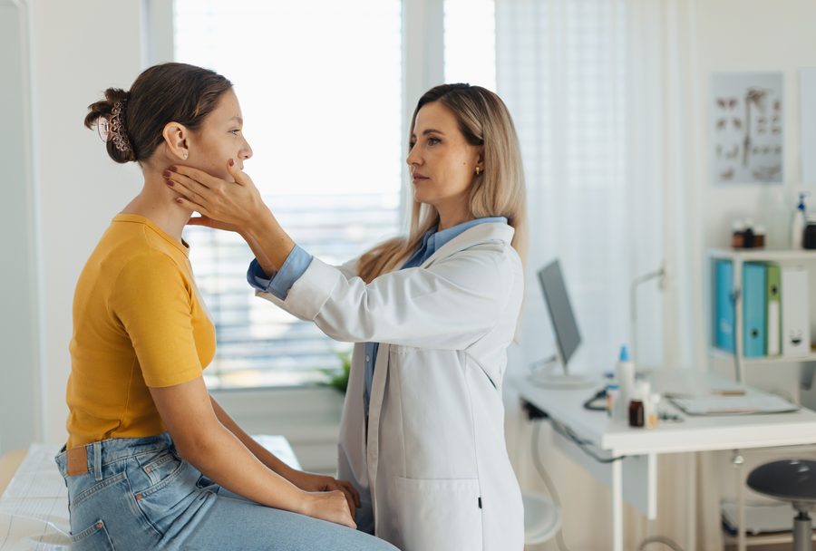 A doctor examining a patient during a routine office visit at Encompass